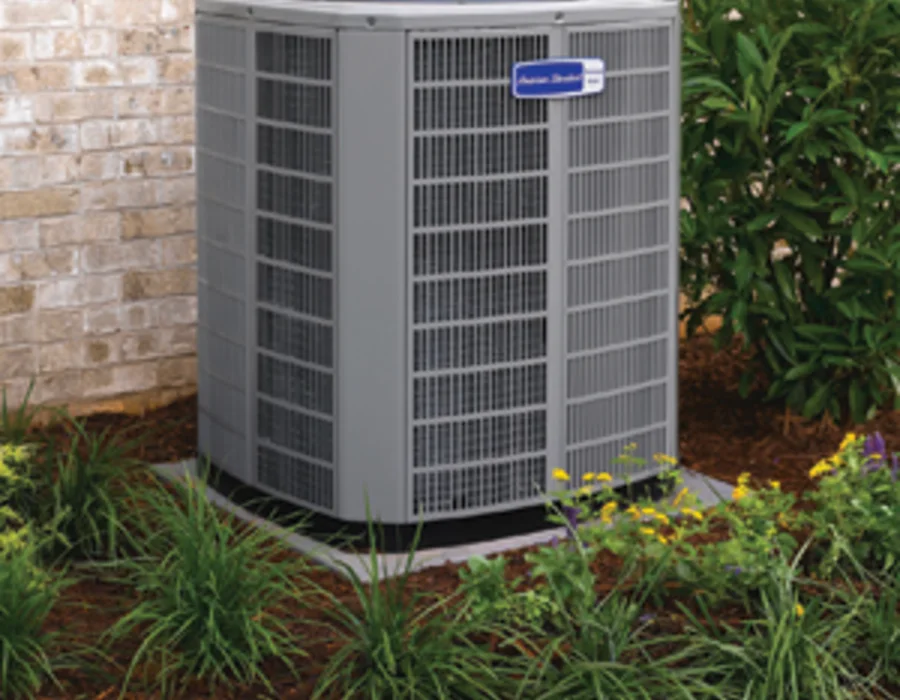 Outdoor air conditioner installed beside a home
